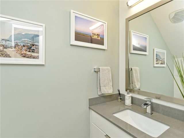 bathroom featuring lofted ceiling and vanity