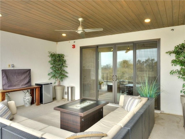 view of patio featuring an outdoor living space with a fire pit and ceiling fan