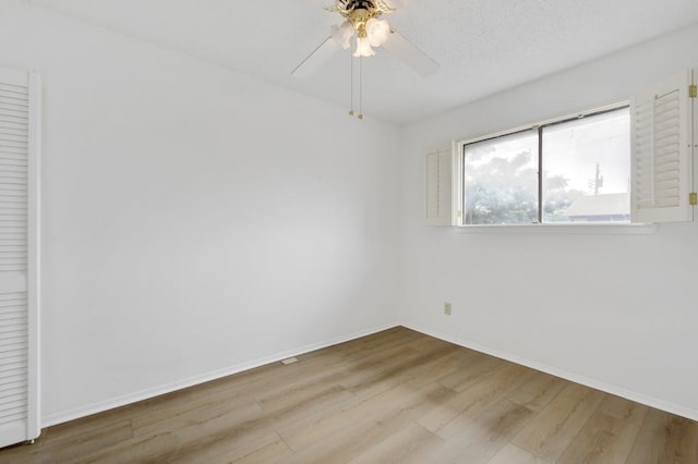 unfurnished room with ceiling fan and hardwood / wood-style flooring