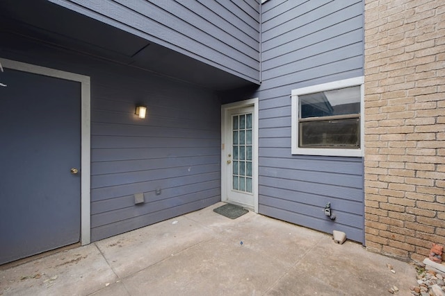 entrance to property with a patio