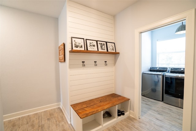 mudroom featuring washer and clothes dryer and light hardwood / wood-style floors