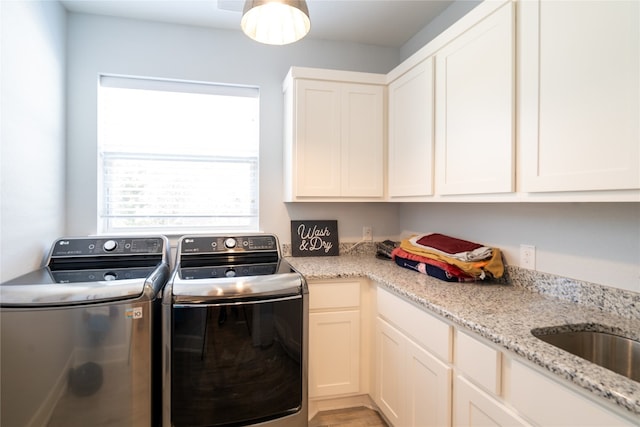 laundry area with cabinets and washer and dryer