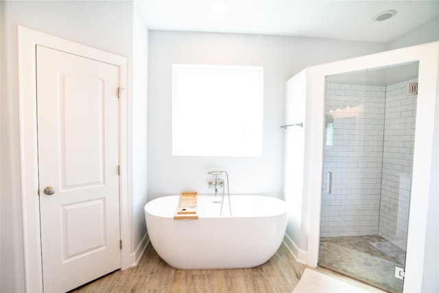 bathroom with wood-type flooring and separate shower and tub