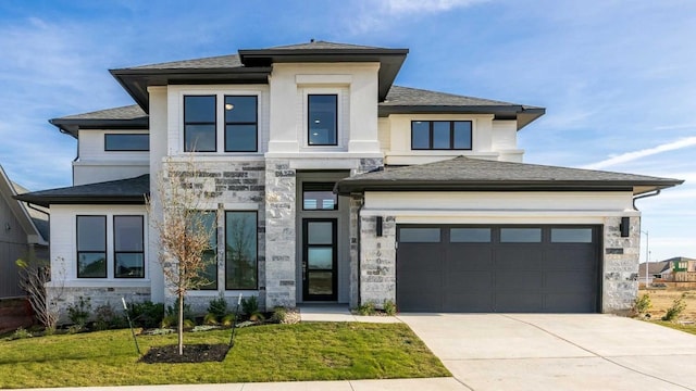 prairie-style home with a front yard and a garage