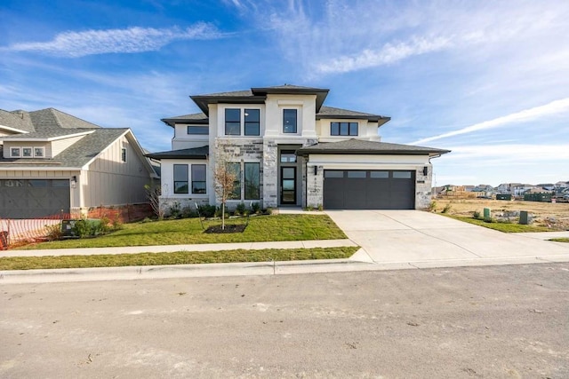 view of front facade with a front yard and a garage