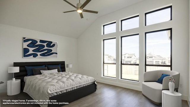 bedroom featuring hardwood / wood-style floors, ceiling fan, and vaulted ceiling