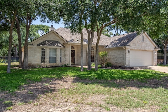 single story home with a garage and a front yard