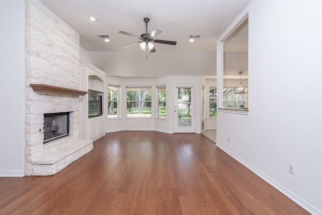 unfurnished living room with a stone fireplace, ceiling fan, and hardwood / wood-style floors