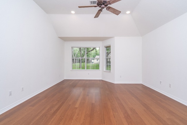 empty room featuring ceiling fan, vaulted ceiling, and hardwood / wood-style floors