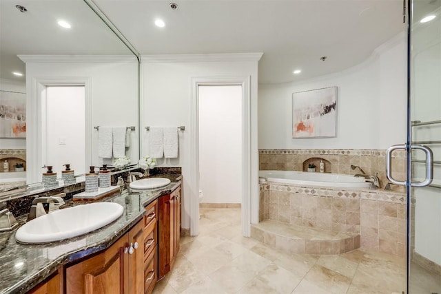 bathroom with a sink, toilet, a bath, and crown molding