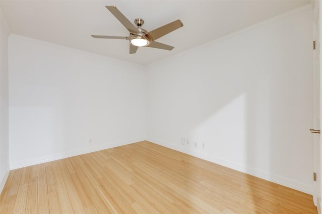 spare room with a ceiling fan, baseboards, and wood finished floors