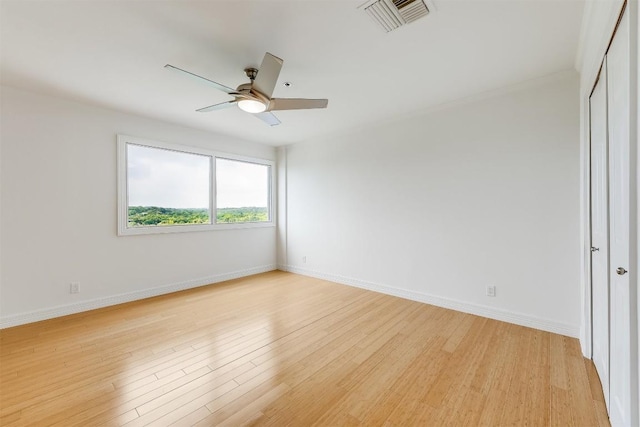 unfurnished room featuring visible vents, baseboards, ceiling fan, and light wood finished floors