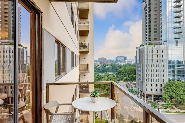 balcony with a view of city and a water view