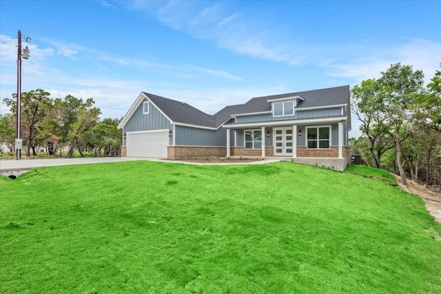 view of front of house with a garage and a front lawn