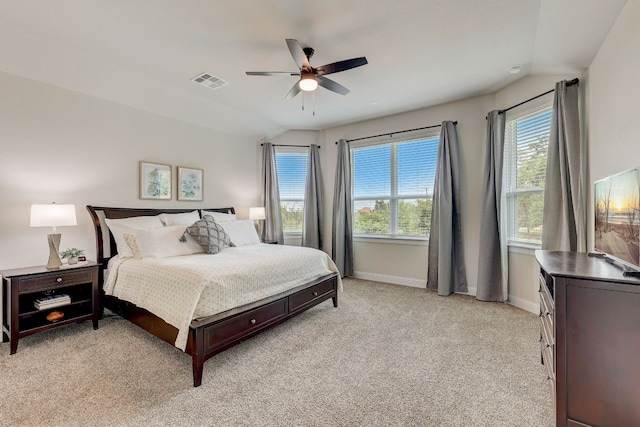 bedroom with ceiling fan, light colored carpet, and lofted ceiling