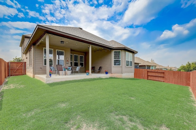 back of house featuring a yard and a patio area