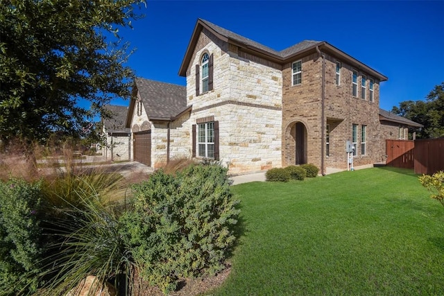 view of front of house featuring a garage and a front lawn