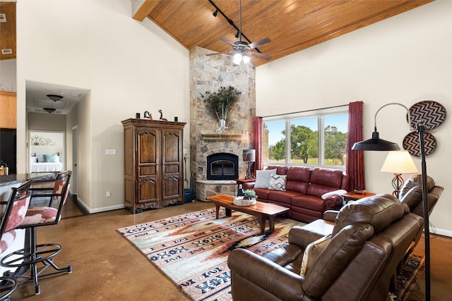 living room with beam ceiling, ceiling fan, a stone fireplace, high vaulted ceiling, and wood ceiling
