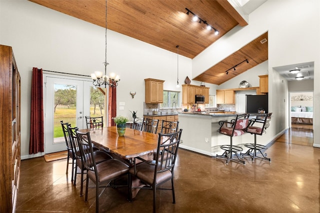 dining room featuring french doors, sink, high vaulted ceiling, a chandelier, and wood ceiling