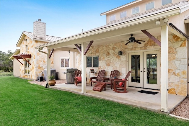 back of house featuring french doors, cooling unit, ceiling fan, a patio area, and a yard