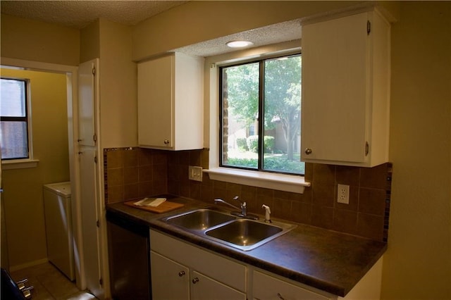 kitchen featuring white cabinetry, sink, and backsplash