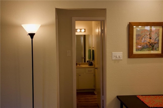 corridor with sink and wood-type flooring