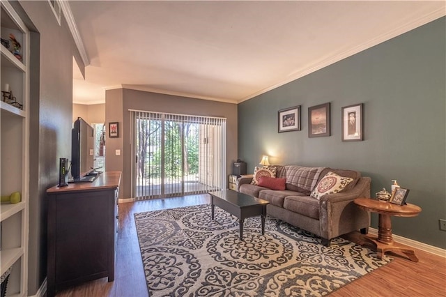 living room with crown molding, built in features, and hardwood / wood-style floors