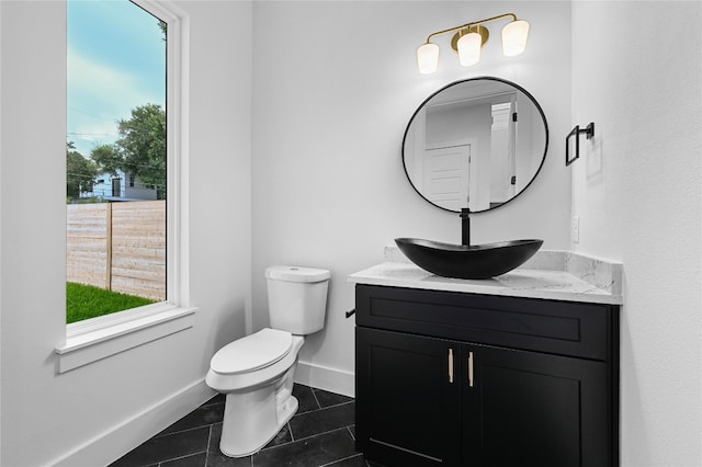 bathroom featuring tile patterned flooring, vanity, and toilet