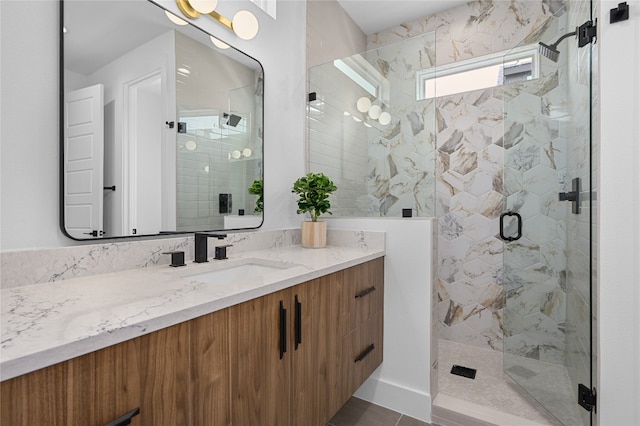 bathroom with vanity, an enclosed shower, and tile patterned flooring