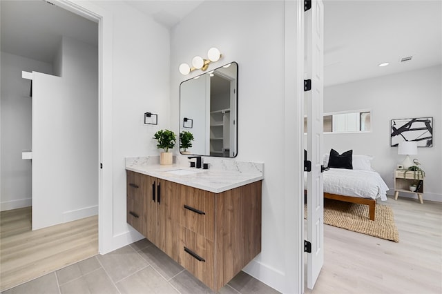 bathroom featuring hardwood / wood-style flooring and vanity