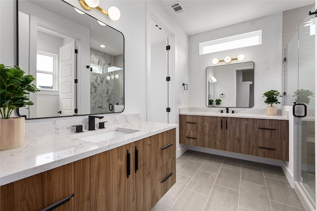 bathroom featuring vanity, tile patterned floors, and walk in shower