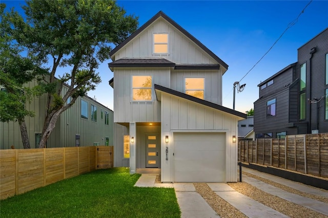 view of front of house with a garage and a lawn