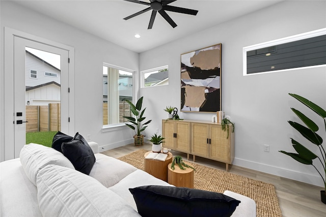 sitting room with light hardwood / wood-style floors and ceiling fan