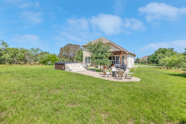 back of house featuring an outdoor fire pit and a lawn