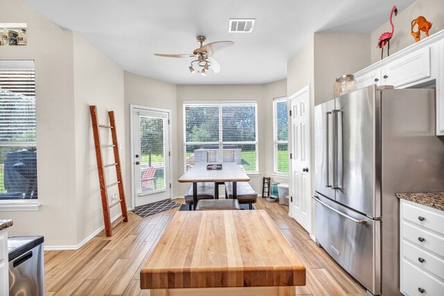 kitchen with white cabinetry, light hardwood / wood-style flooring, ceiling fan, and high quality fridge