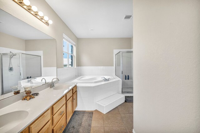 bathroom featuring dual vanity, tile patterned floors, and independent shower and bath