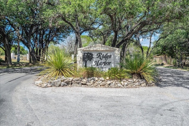 community sign featuring a garage