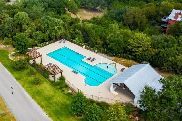 pool with a patio area and fence