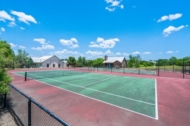 view of tennis court with fence