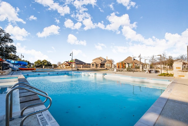 view of pool with a water slide