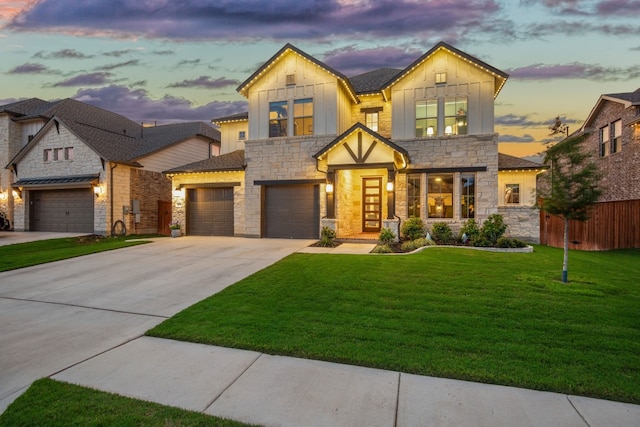 view of front of house with a garage and a yard