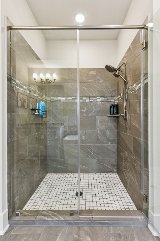 bathroom featuring a shower with door