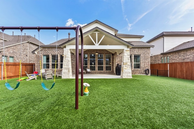 rear view of property with a playground, a patio area, and a lawn