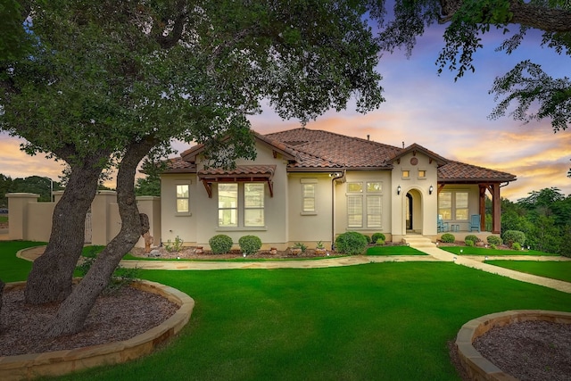 mediterranean / spanish-style home featuring a lawn