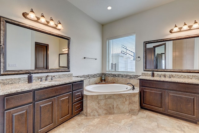 bathroom featuring vanity, tile patterned floors, and a relaxing tiled tub