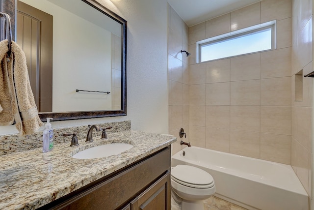 full bathroom with vanity, toilet, and tiled shower / bath