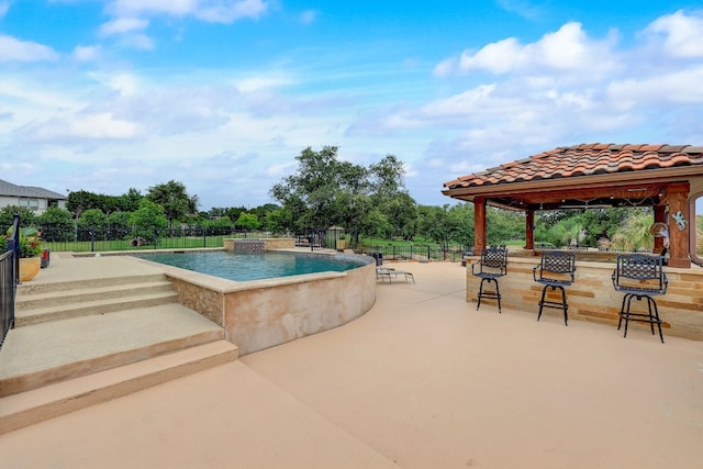 view of swimming pool featuring a patio and a gazebo