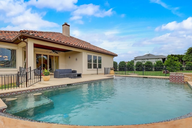 view of swimming pool with ceiling fan, an outdoor hangout area, and a patio