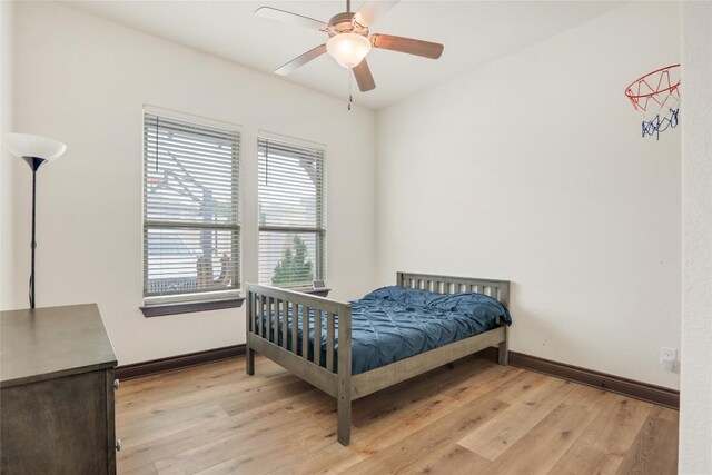 bedroom with ceiling fan and light hardwood / wood-style floors