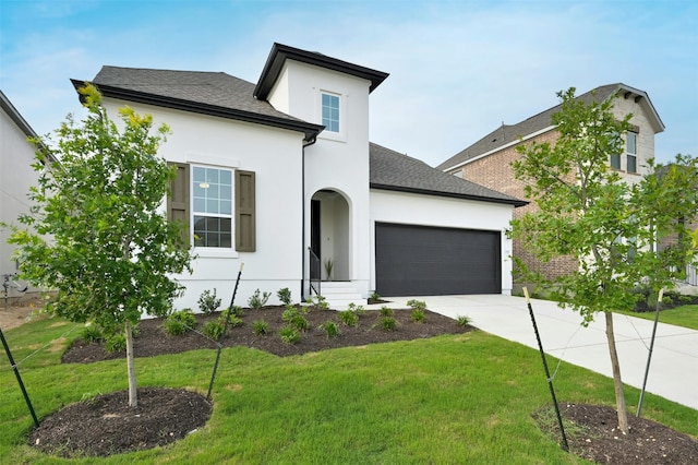 view of front facade with a garage and a front lawn